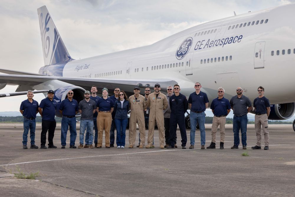 The team takes a photo on tarmac in front of the Flying Test Bed