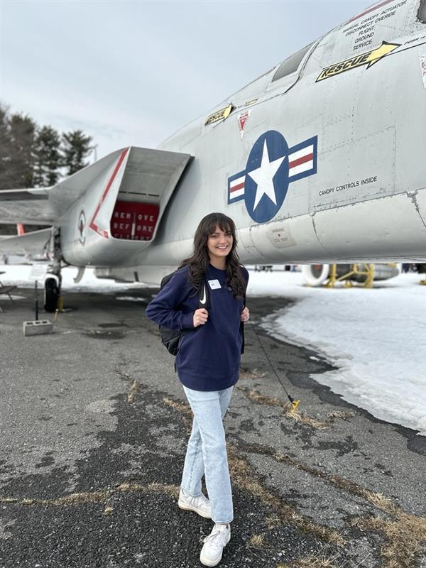Woman standing in front of a jet