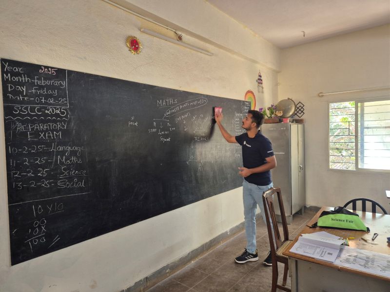 Man writing on a chalkboard