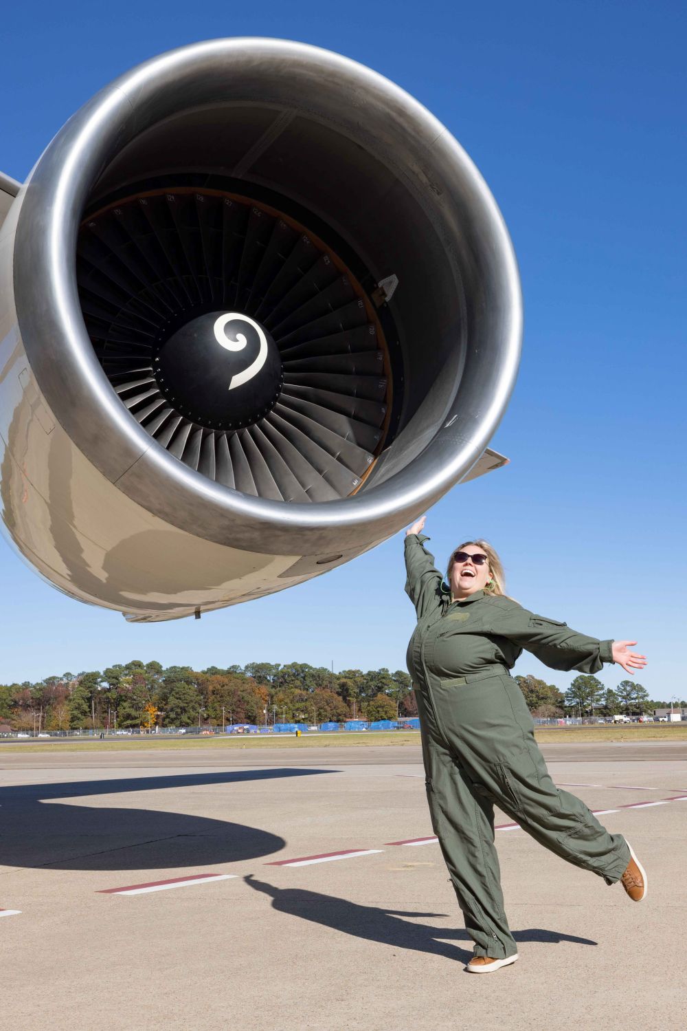 Cassi posing in front of jet engine