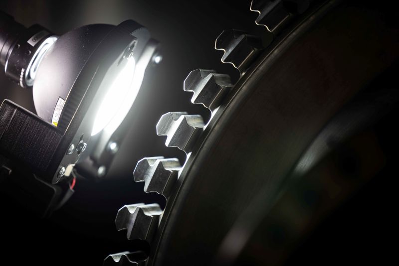 Up close image of a gear with a white light
