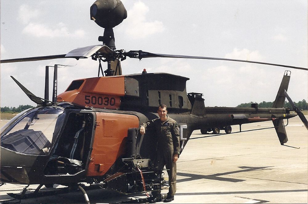 One-time Black Book program manager Tom Climer poses with an OH-58D Kiowa Warrior Helicopter during a 1988 training session in Ft. Rucker, Alabama