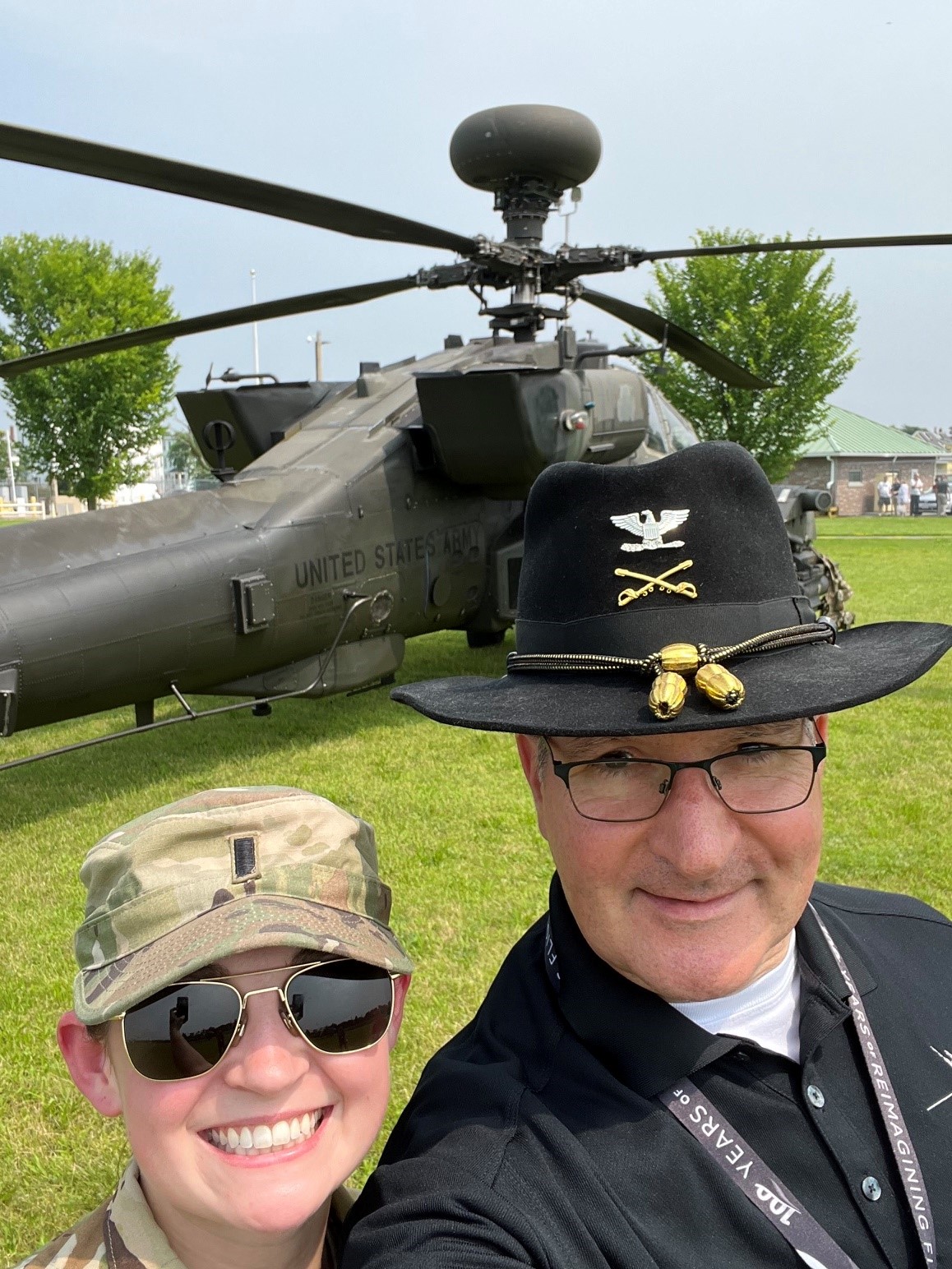 Climer and his niece Maggie Brehm smile in a selfie in front of a helicopter at the Lynn, Massachusetts facility, the aircraft similar to the ones Brehm now flies as an Army helicopter pilot