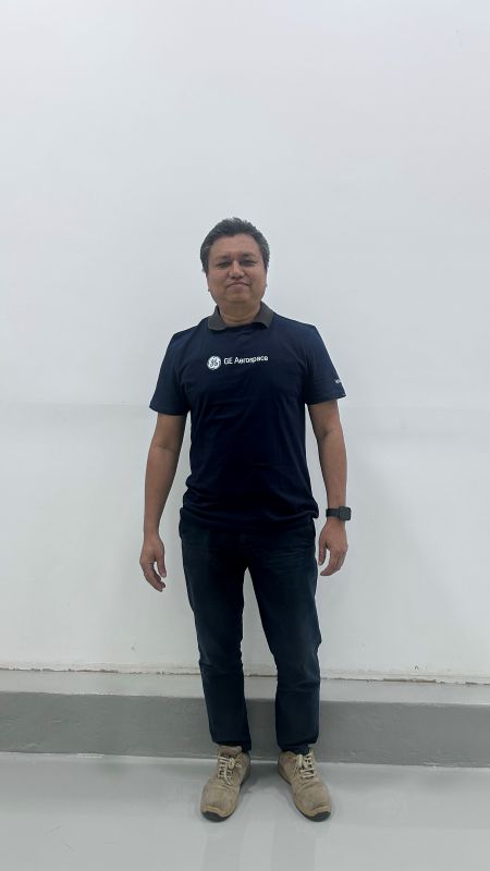 Man standing against a white wall