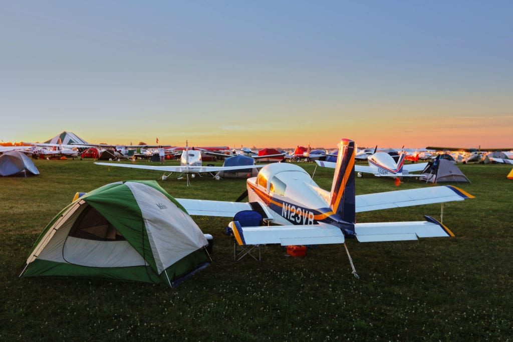 The majority of pilots who fly in sleep in tents next to their planes during the week-long event.