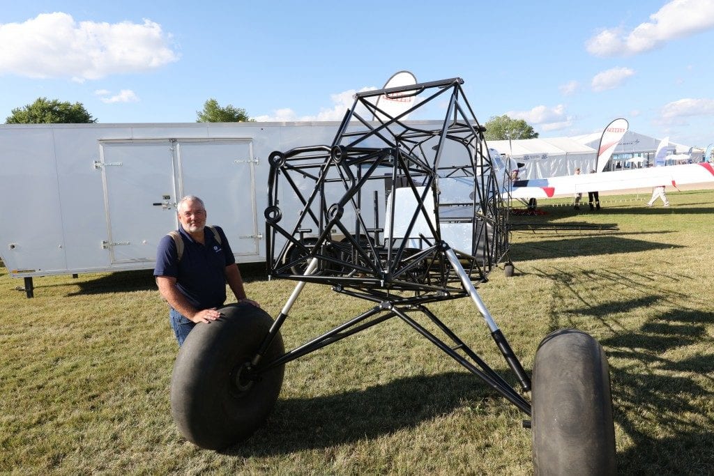 Above: Jeff Beam is building a Piper Cub in his garage similar to this one. Top: Beam next to his red Hatz biplane. He flew it 800 miles from Kansas to Oshkosh.