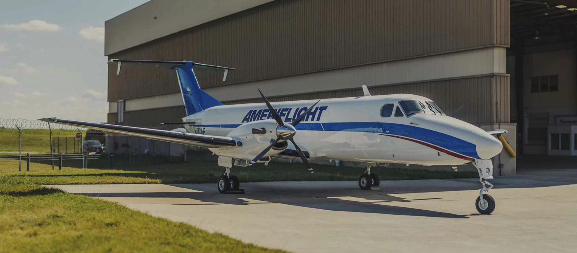 Plane parked outside hangar
